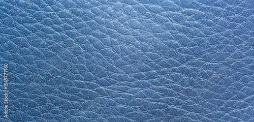 Close-up macro blue synthetic leather,Close up, macro texture of blue glossy natural genuine leather, leatherette structure, artifical skin surface with embossed pattern. Background, wallpaper, 