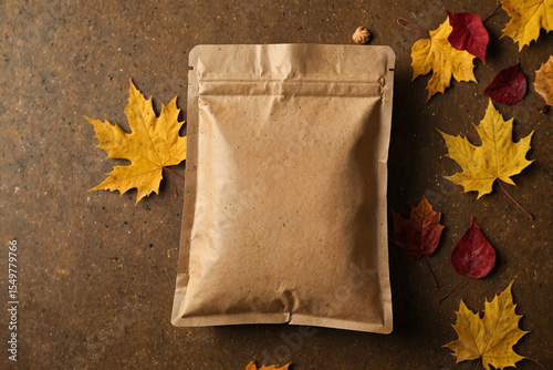 empty paper bag autumn leaves on a wooden background