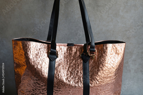 Shimmering Rose Gold Tote Bag with Bold Black Handles