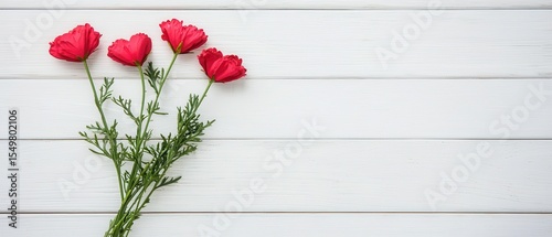 Beautiful Pink Flowers on White Wooden Surface with Green Leaves
