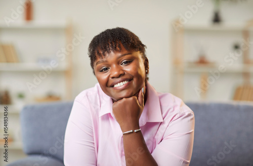 Happy smiling attractive middle aged african american woman looking at camera with beautiful toothy smile, posing for female portrait at home, lifestyle wellness, positive satisfied housewife joy