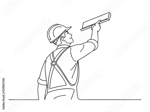A man working in uniform plastering the wall indoors