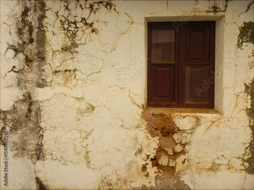 Old wooden window in an old white facade