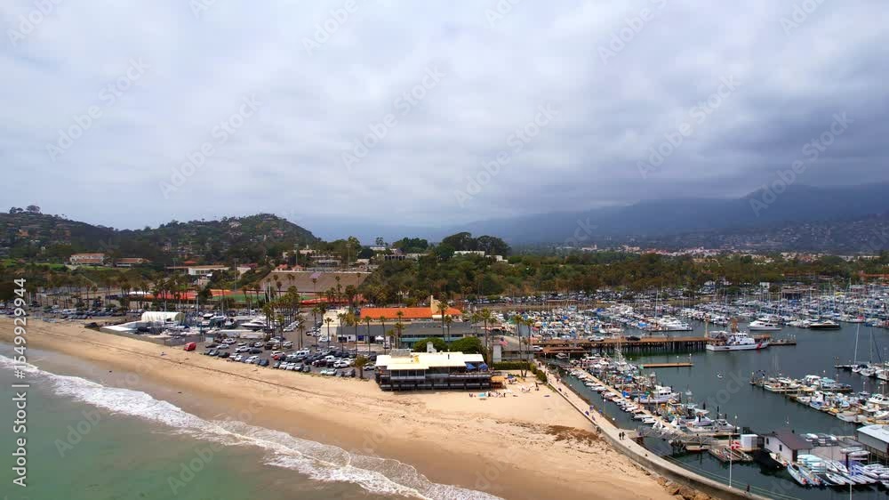 Aerial view of world famous Santa Barbara with mountains as dramatic backdrop. West Coast California USA. Pacific Ocean. Cliffs with palm trees and a huge marina port with hundreds of boats Aerial view of world famous Santa Barbara with mountains as dramatic backdrop. West Coast California USA. Pacific Ocean. Cliffs with palm trees and a huge marina port with hundreds of boats