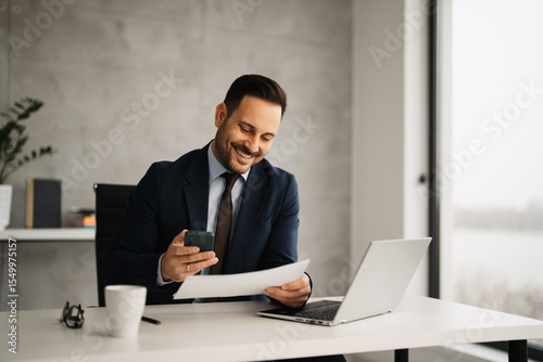 Handsome businessman in suit working in his office