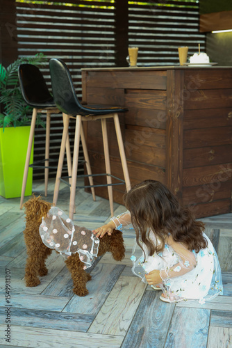little girl playing with a dog