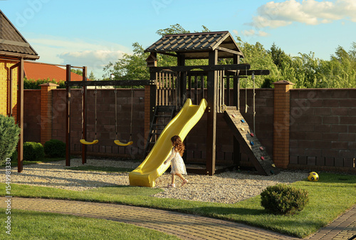 a girl is walking on the playground