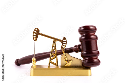 Golden miniature oil pump and hammer judge on white background