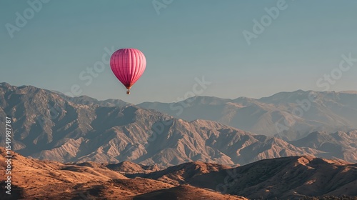 Pink hot air balloon ride over mountain range scenic landscape travel sky