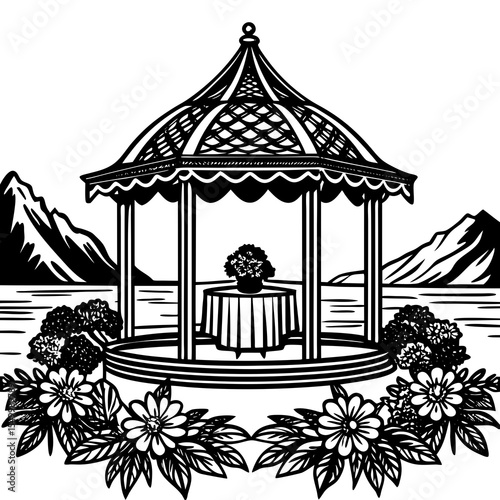 Gazebo with flowers and mountain backdrop on a lake in black and white