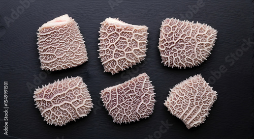 Display Of Honeycomb Tripe On A Dark Tabletop Ready For Cuisine Preparation photo