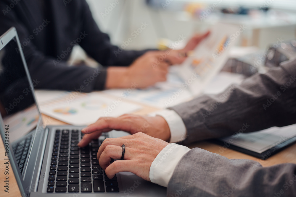Business team discuss and explain marketing plan to plan financial strategy for business owner using laptop, calculator, chart sheet to calculate and summarize results. Business and finance concept. Business team discuss and explain marketing plan to plan financial strategy for business owner using laptop, calculator, chart sheet to calculate and summarize results. Business and finance concept.