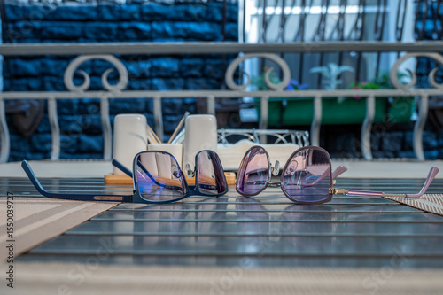 Eyeglasses lie on table in a street cafe.