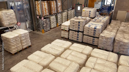 Tilting of large warehouse with pallets and shelves with bags of food products. Storage of cargo according to international standards. High angle view. No people