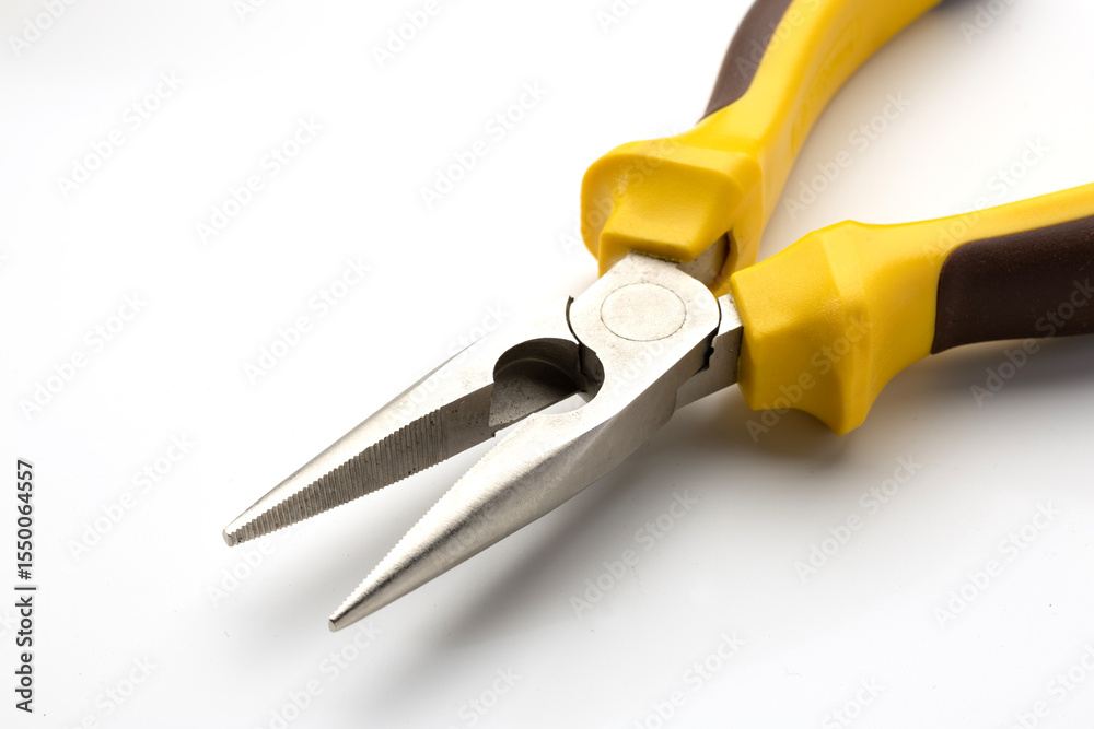 Obraz premium Pliers with yellow and black rubber grips on a white background. The tool features pointed jaws, ideal for precision work and gripping small objects.