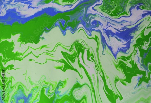 Abstract blue-white-green background. Acrylic paint flows freely and creates an arbitrary pattern. Bright shades. The effect of a stone, a sea wave.