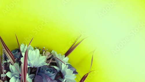 Bouquet of blue flowers on a light yellow background. Festive flower arrangement with a place for text.