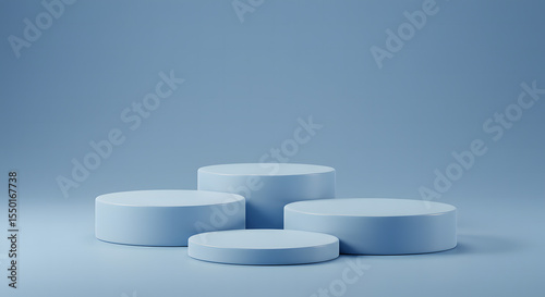 Four minimalist light blue cylindrical podiums arranged in a staggered formation on a light blue background