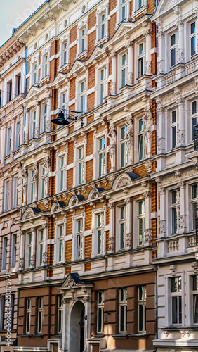Historic row of colorful European buildings showcasing ornate architectural details including wrought iron balconies and decorative facades, in a picturesque cityscape, Wroclaw, Poland
