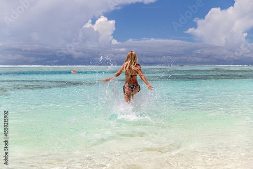 A Joyful Girl Filled with Energy Running on the Beach