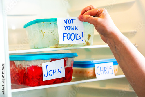 Office fridge with angry Do Not Touch My Food stickers on meal containers. Workplace humor, coworking content.