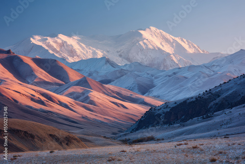 breathtaking view of lenin peak under clear sky illuminated by soft morning light