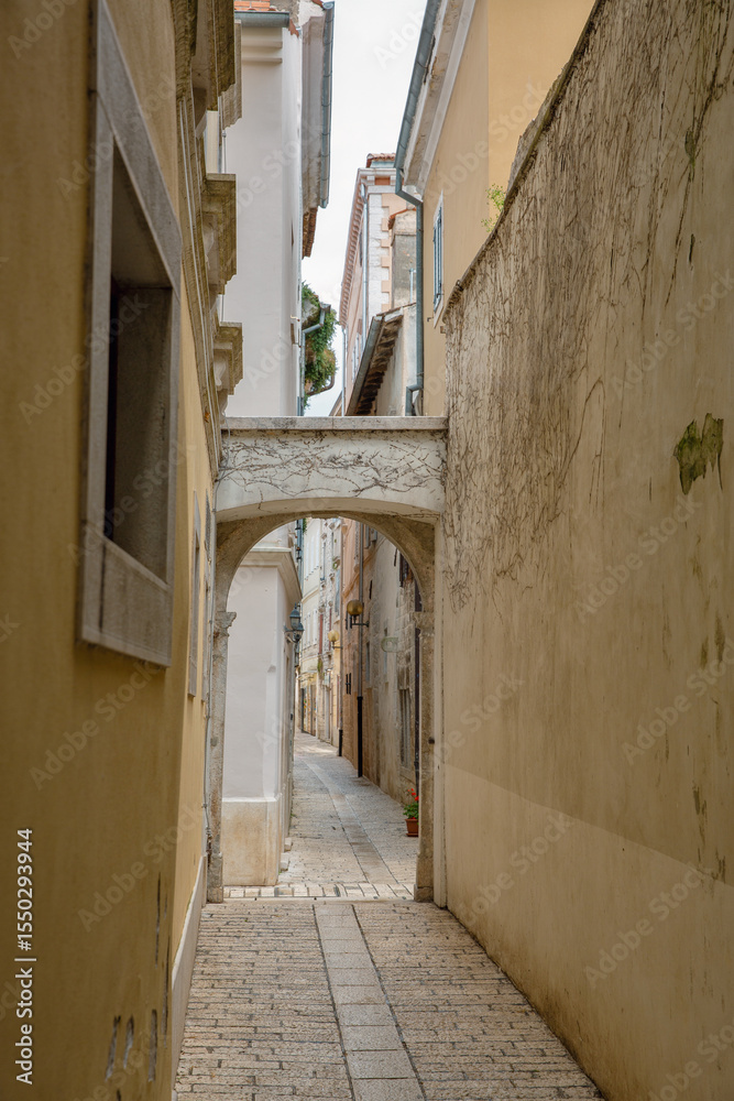 Narrow stone alley with arch. Old European town Porec, Croatia. Narrow stone alley with arch. Old European town Porec, Croatia.