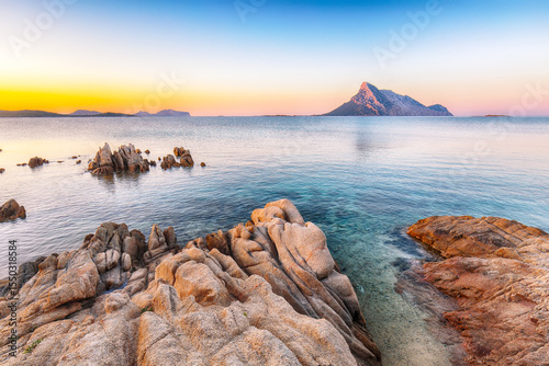 Fototapeta Naklejka Na Ścianę i Meble -  Superb evening scene of Porto Taverna beach with Tavolara mountain on background.