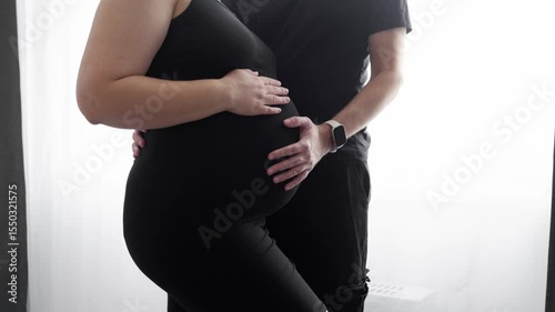 unrecognisable future parents hands on pregnant belly close up. Couple expressing protection, love and gentle to their future baby. Concept of maternity and pregnancy care