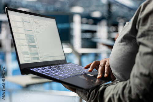 Close up of laptop used by data center software developer to upgrade system stability. Server hub IT professional coding, optimizing performance with device, configuring gear
