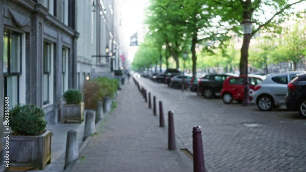 Blurred perspective of an amsterdam street with bokeh effect, showcasing tree-lined sidewalks, parked cars, and historical architecture in the background. Blurred perspective of an amsterdam street with bokeh effect, showcasing tree-lined sidewalks, parked cars, and historical architecture in the background.