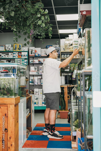 Shopper examining aquariums in fish store
