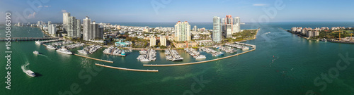 Panorama of Miami skyline and Biscayne Bay. Panoramic cityscape with coastal skyscrapers. Scenic view of Miami Beach from above. Drone captures Fisher Island and waterfront.