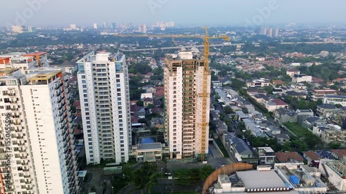 This footage shows an aerial view of Jakarta, Indonesia. Features apartment buildings, a construction site, and a residential neighborhood. The camera pans slightly.