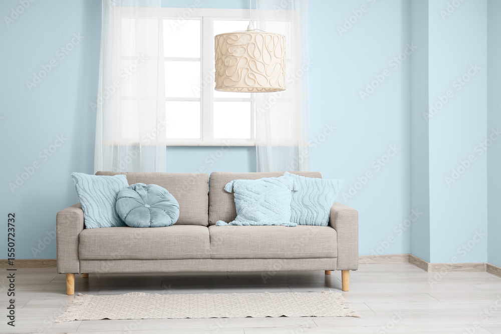 Fototapeta premium Interior of living room with sofa and light blue elements