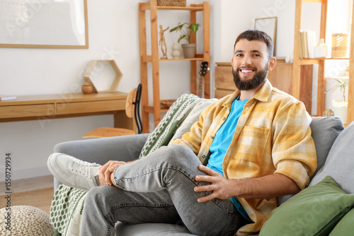 Young bearded man sitting o...