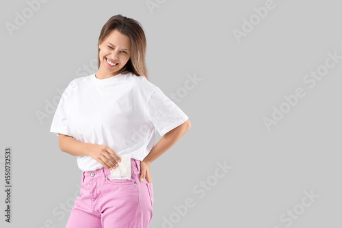 Young woman putting menstru...