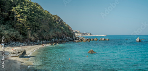 Fototapeta Naklejka Na Ścianę i Meble -  Michelino beach famous beach in the municipality of Parghelia; on background: the town and the marina of Tropea. Vibo Valentia province, Calabria, Italy