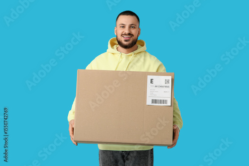 Young man with parcel on bl...