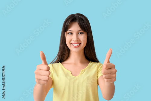 Smiling young woman showing...