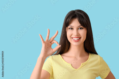 Smiling young woman showing...