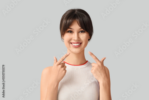 Young woman pointing at her...