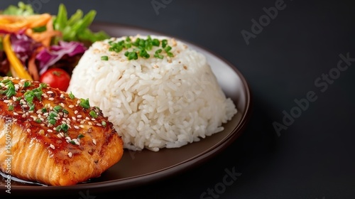 Grilled Salmon with Teriyaki Sauce Served with Rice and Fresh Vegetables on Dark Background