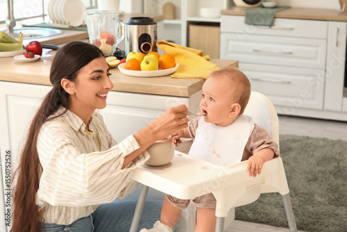 Mother feeding her baby wit...