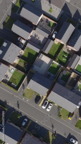 Vertical top down aerial view of new build suburban houses in the United Kingdom. Housing market and suburban lifestyle concept