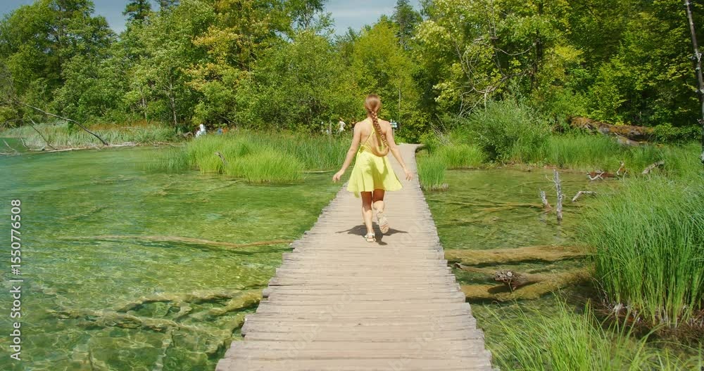 custom made wallpaper toronto digitalWoman crossing wooden path over clear lake in Plitvice in summer