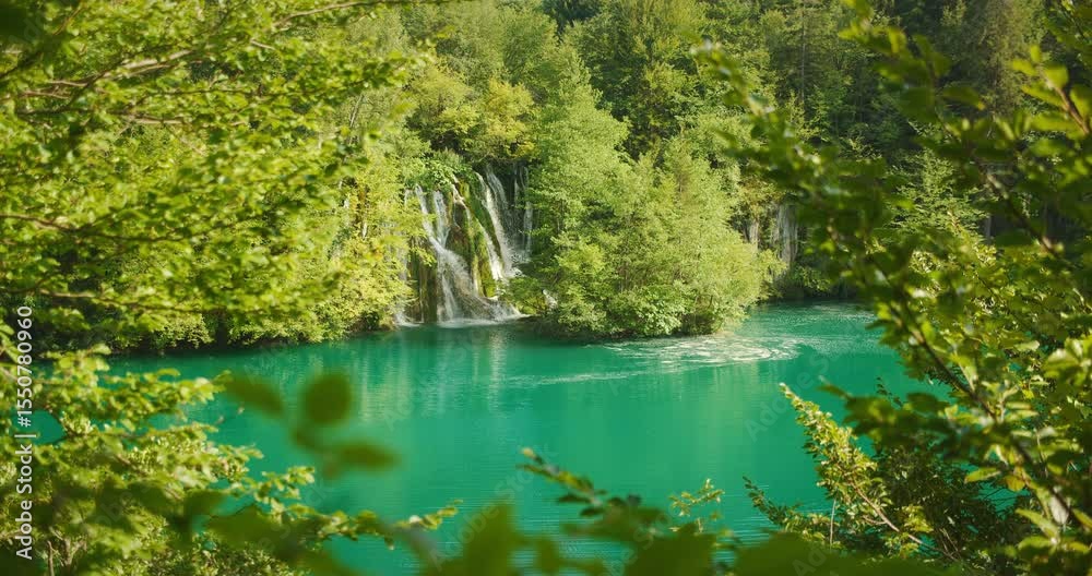 custom made wallpaper toronto digitalWaterfall emerging from dense green foliage into calm turquoise lake in Croatia