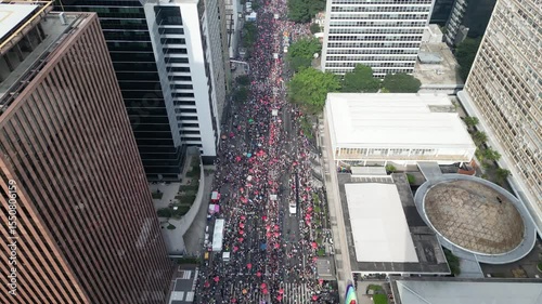 High-altitude drone shot with rising gimbal revealing large crowd at São Paulo LGBT Pride Parade – 4K