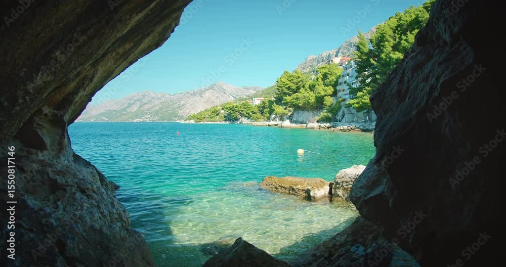 custom made wallpaper toronto digitalView from a rocky cave opening toward turquoise sea and coastal town in Croatia