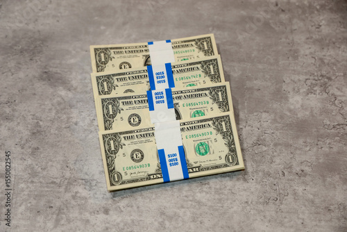 Four American one dollar bill straps with 100 dollars each.
